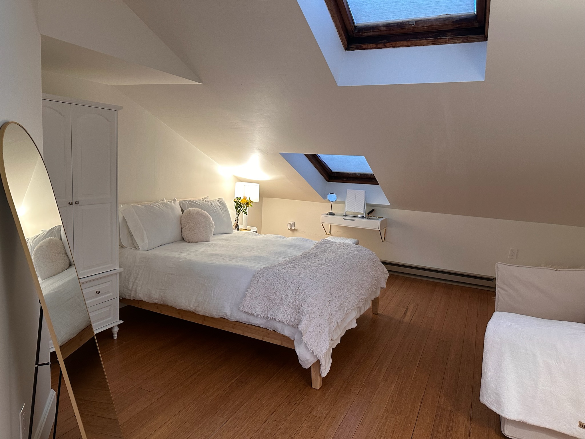 Upstairs bedroom under vaulted ceiling with skylights